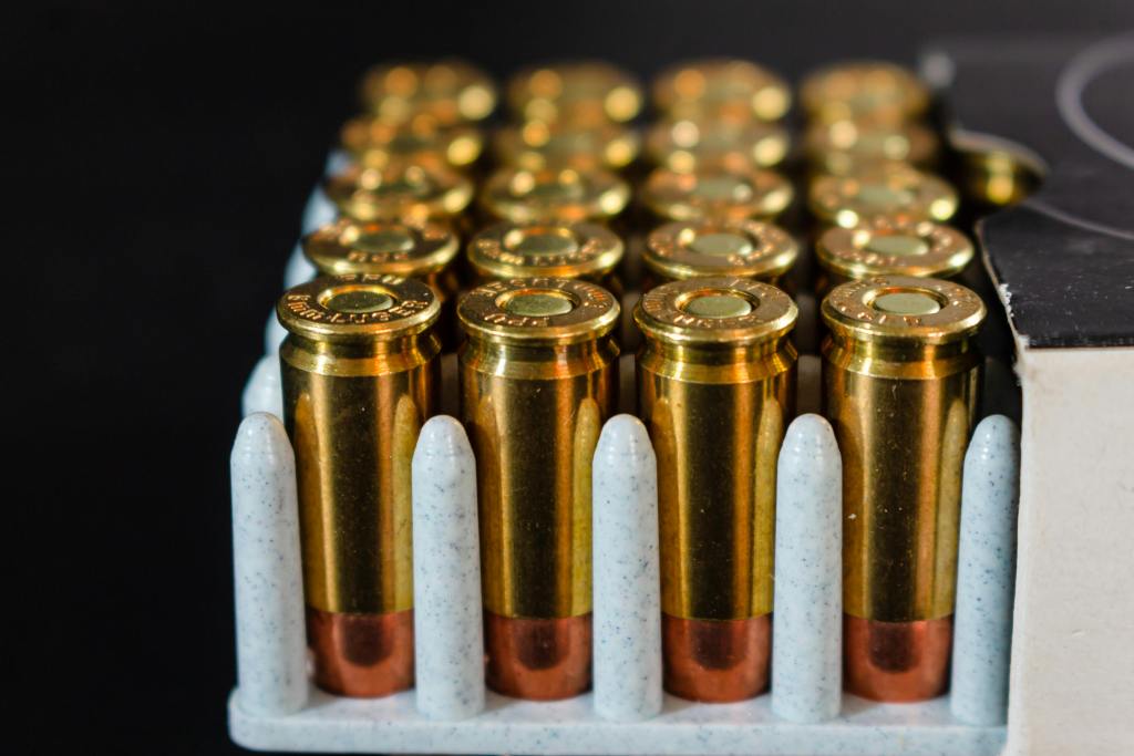 pexels-photo-18206461-18206461 Detailed view of ammunition bullets neatly arranged in a box, showcasing brass casings and copper tips.